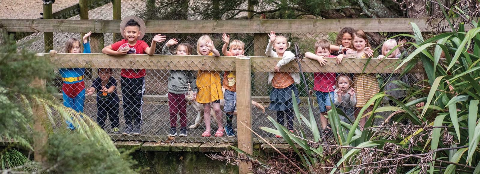 A birthday group lined up along the fence
